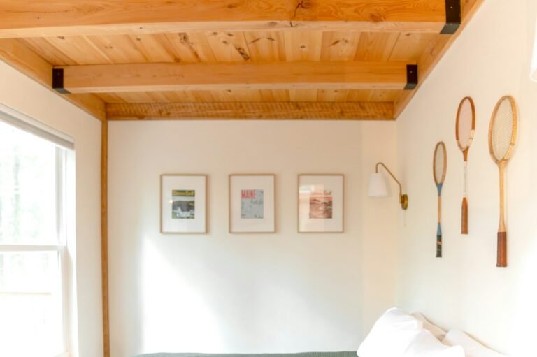 Light coastal interior with natural wood and wall decor